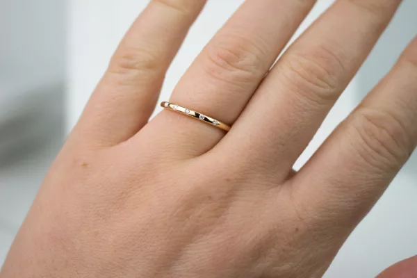 Tragebild eines Verlobungsringes aus Rosegold mit Diamanten. Der Ring ist filigran und rund. Er besticht surch sein klassisches und modernes Design.