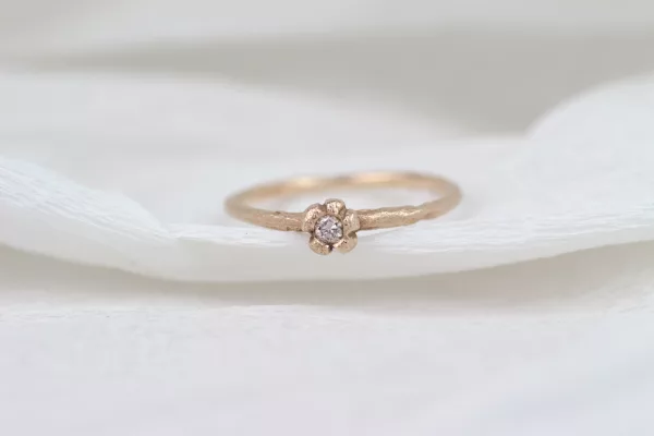Verblüffender Verlobungsring aus Rotgold mit einem seltenen braunen Brillanten. Das einzigartige Design, das eine zarte Blume um den Diamanten formt, verleiht diesem Ring eine natürliche und zeitlose Schönheit.